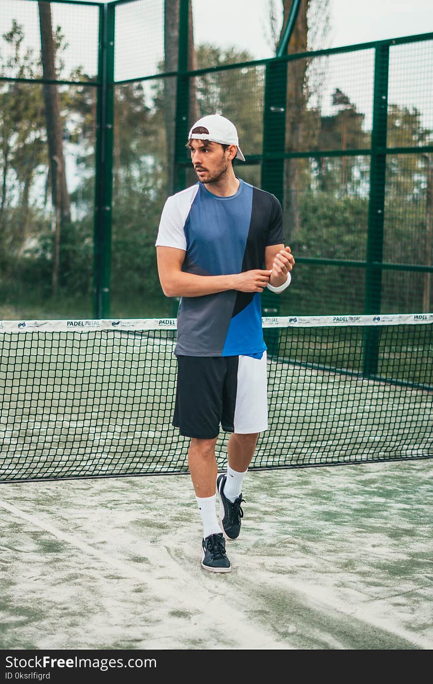 Man Wearing Blue and White Crew-neck Shirt and Shorts