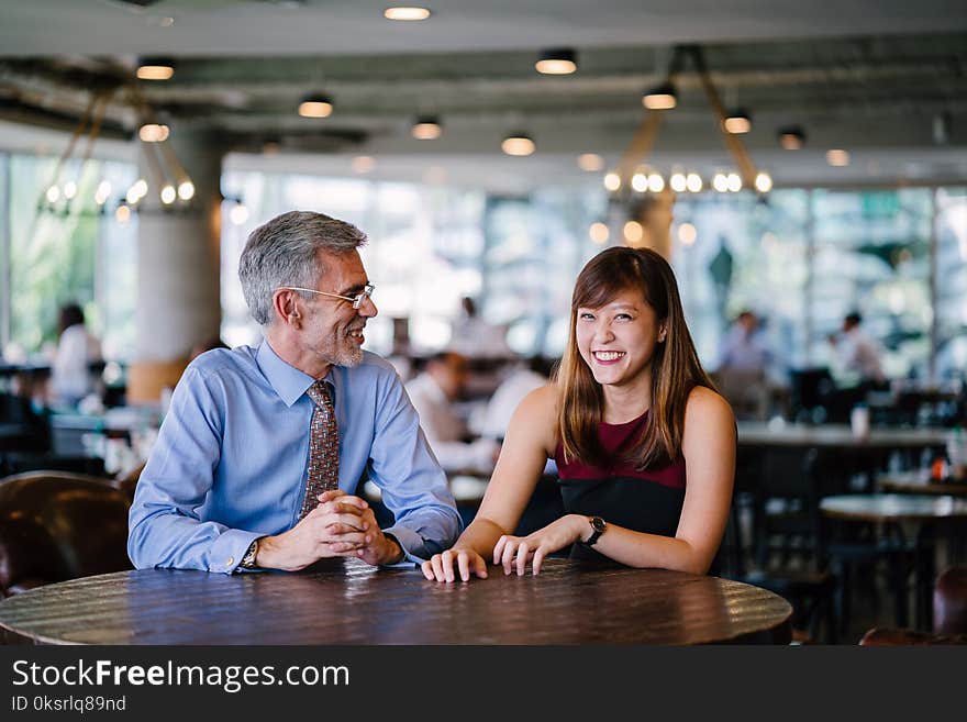 Photography of Man and Woman Sitting Together