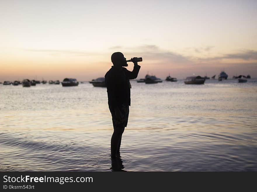 Silhouette Photo Of Man Drinking