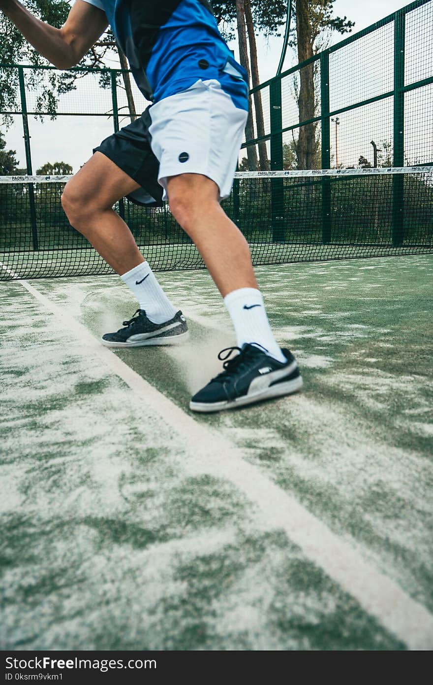 Close-up Photo of Man Standing on Tennis Court