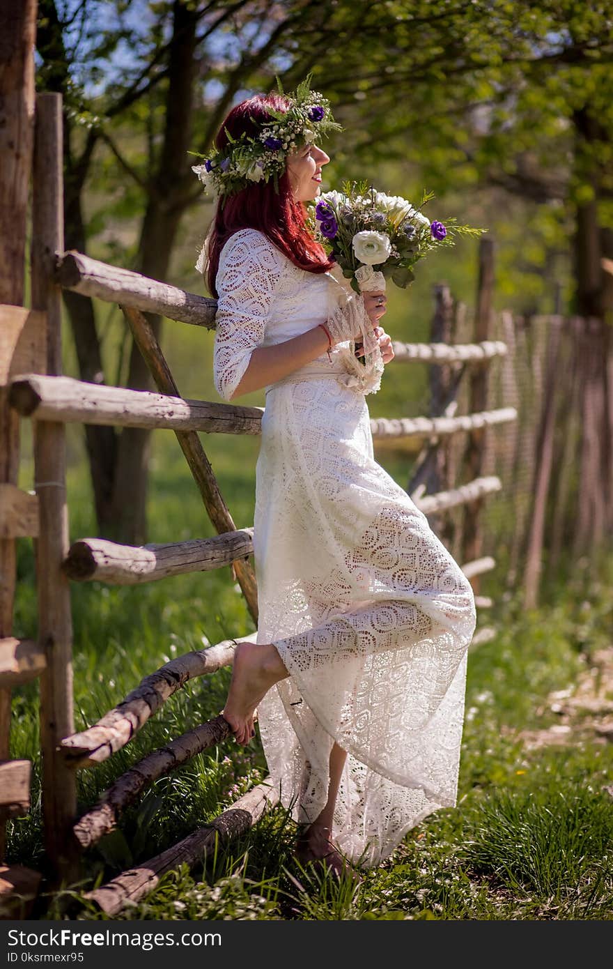 Woman In White Long-sleeved Gown Holding Flower Bouquet