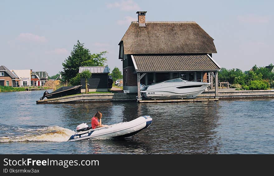 Person on White Inflatable Speed Boat