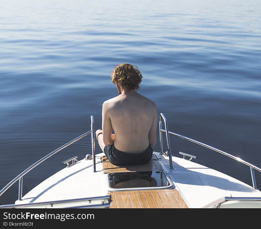 Man in Black Shorts on Boat End