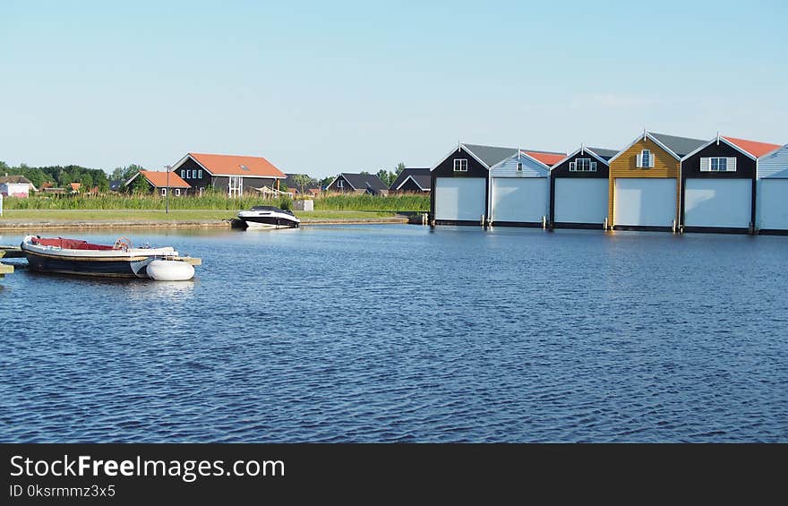 White and Black Powerboat Beside Green Grass