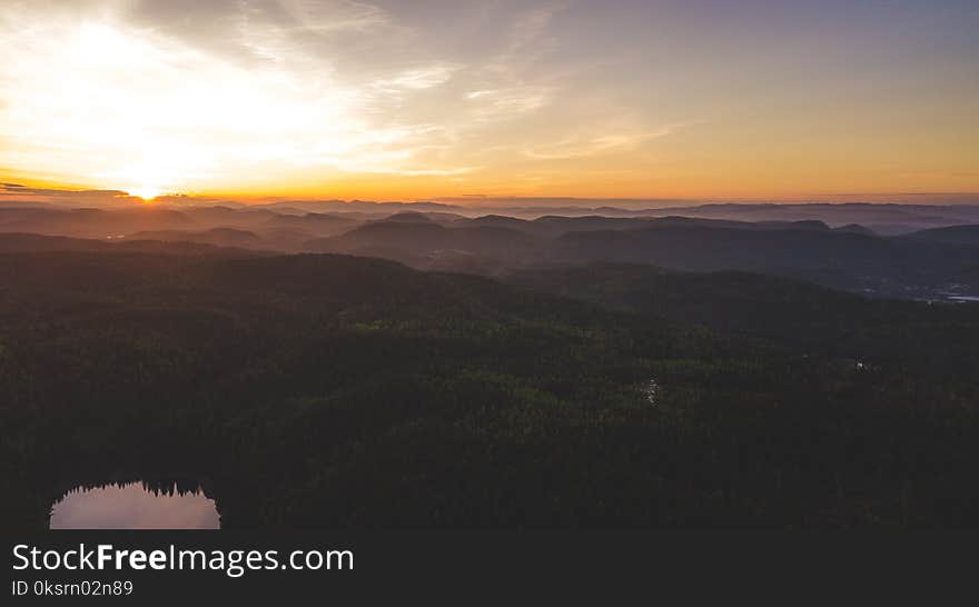 Aerial Photography of Green Mountain Under White Clouds