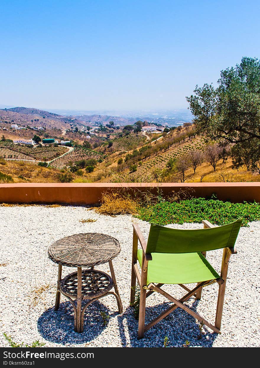 Photo of Green and Brown Folding Chair Near Wicker Table