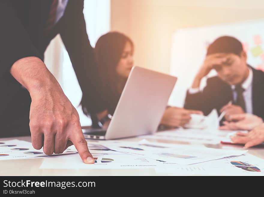 Hands pointing on data chart sheet for business meeting