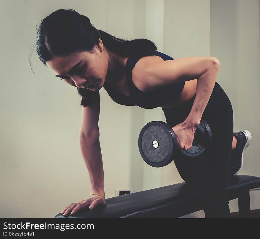 Strong Skinny Woman Is Lifting Dumbbell