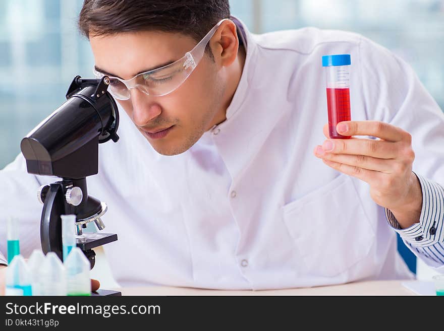 The male chemist working in lab