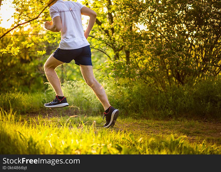 Athletic young man running in nature