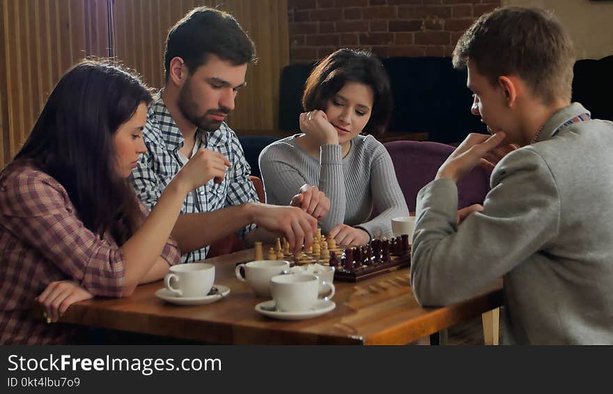 Young men and women playing chess