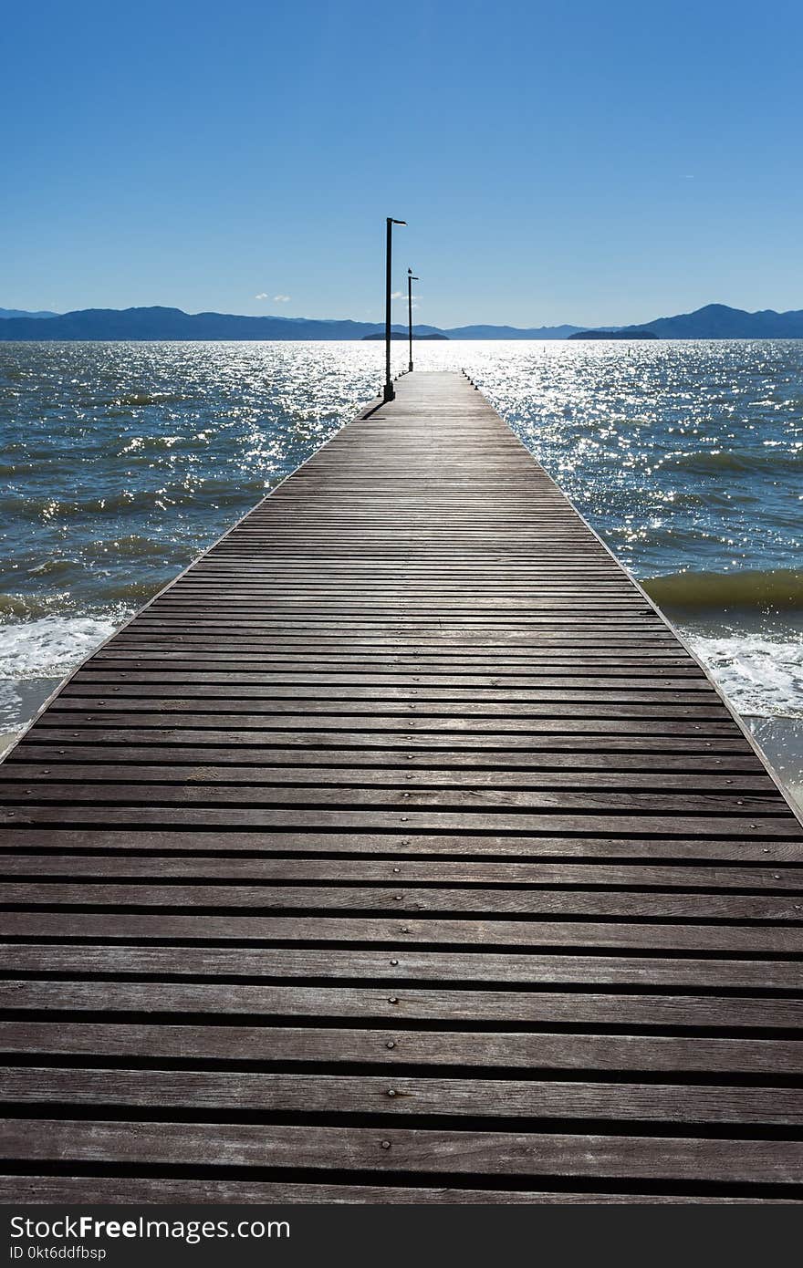 A beautiful image of a pier in a Cacupé Beach in a sunny day