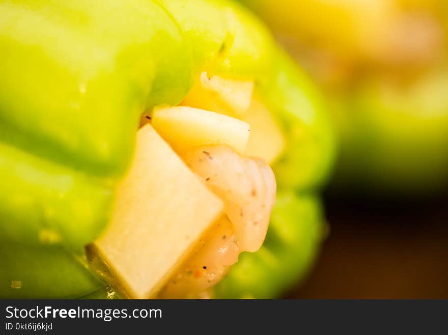 Green paprica filled by potatos and chicken breast pieces to make a meal