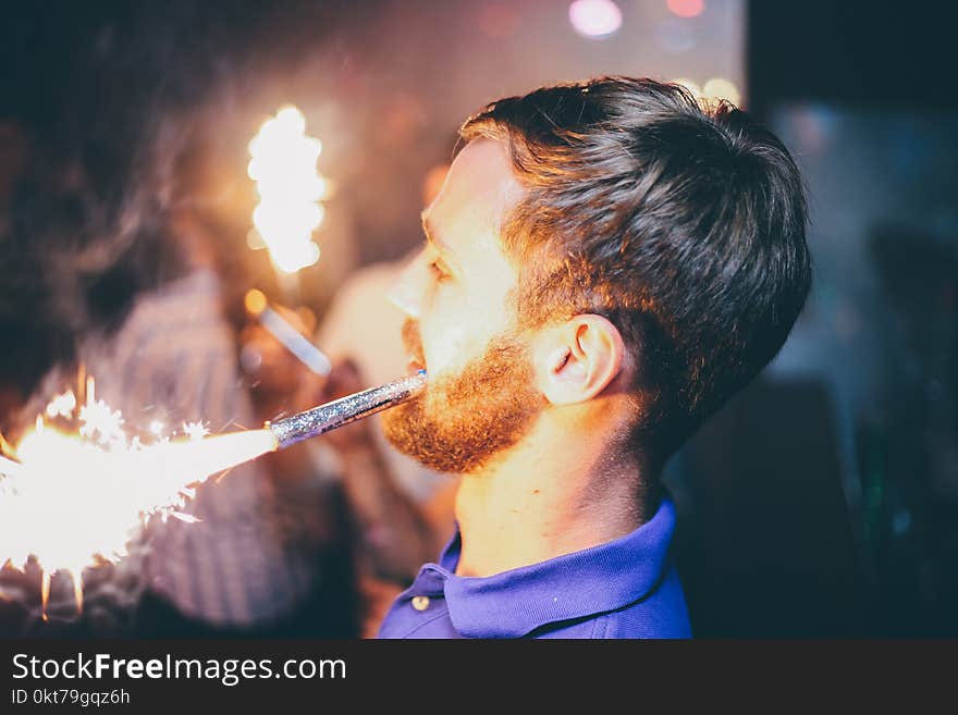 Person Holding Fireworks by Mouth