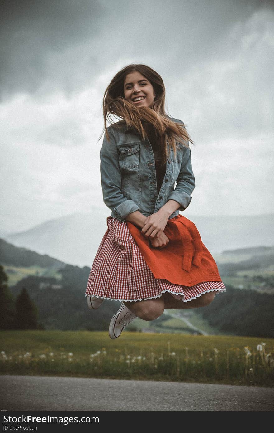 Woman in Blue Denim Jacket Jumping