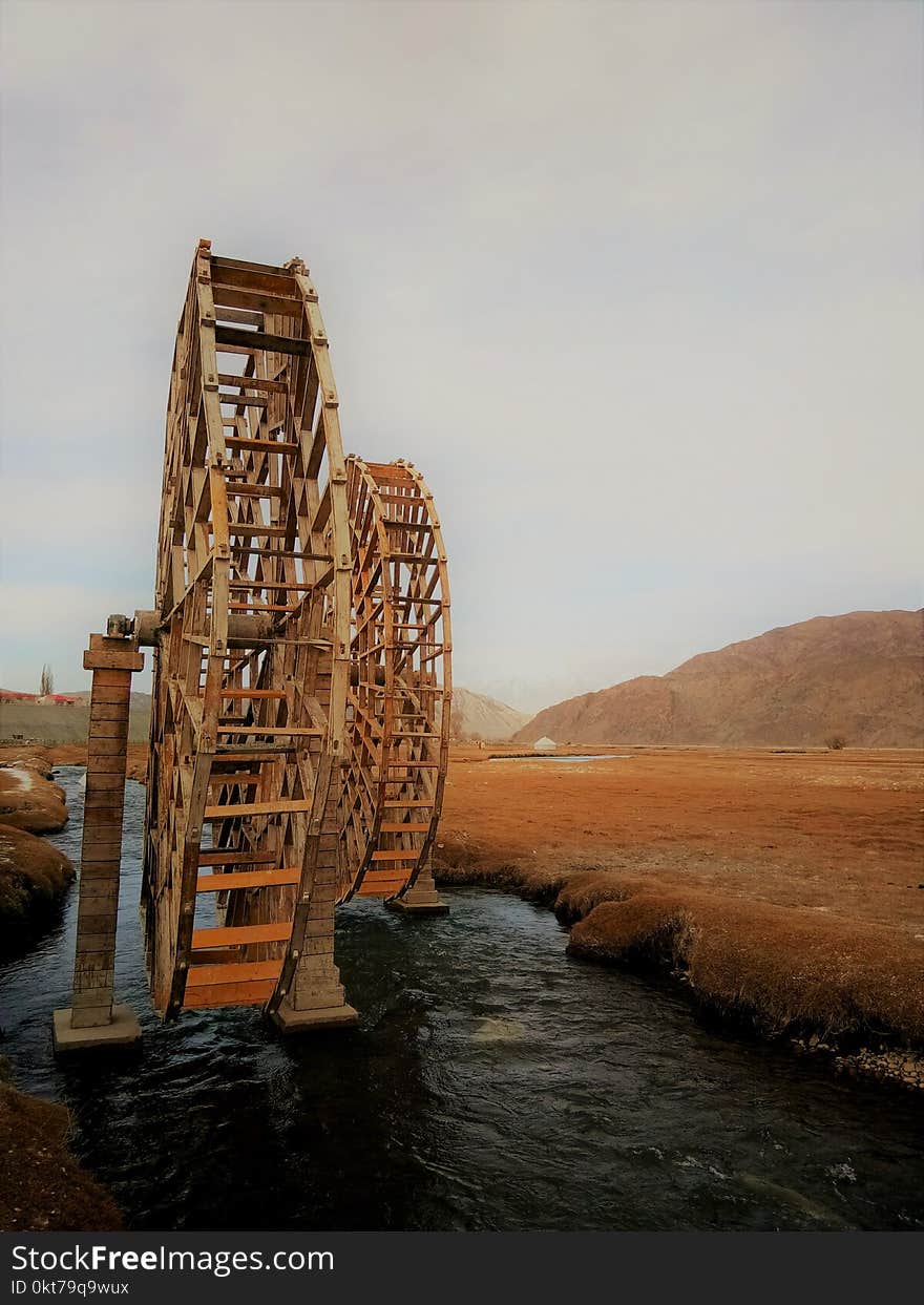 Brown Wooden Wheel on River