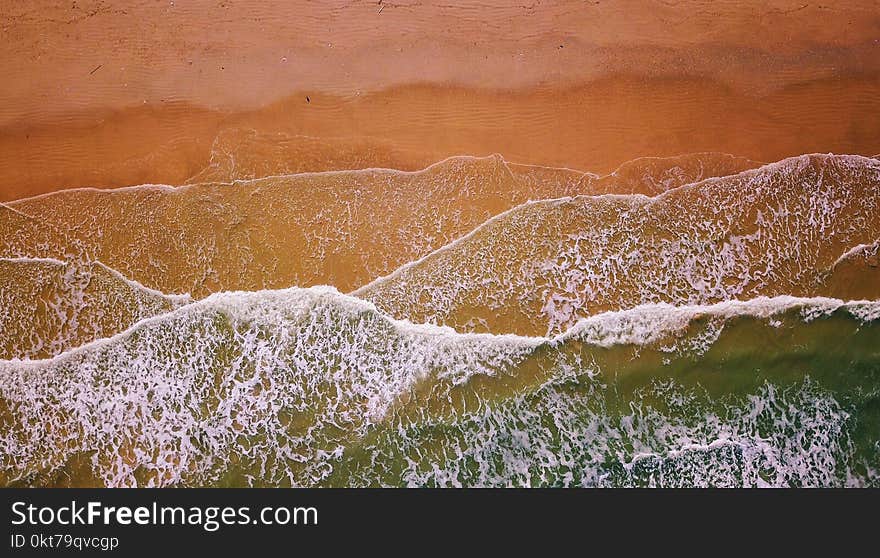 Aerial Photography of Flow of Water Near Sand