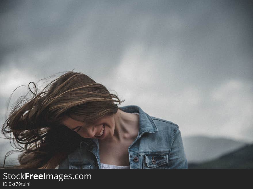 Woman Wears Blue Denim Top and White Inner Smiling