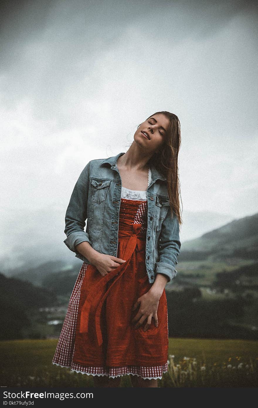 Woman in Red and White Dress Posing for Photo