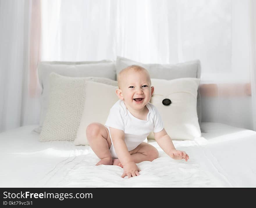 Laughing Baby Wearing White Shirt