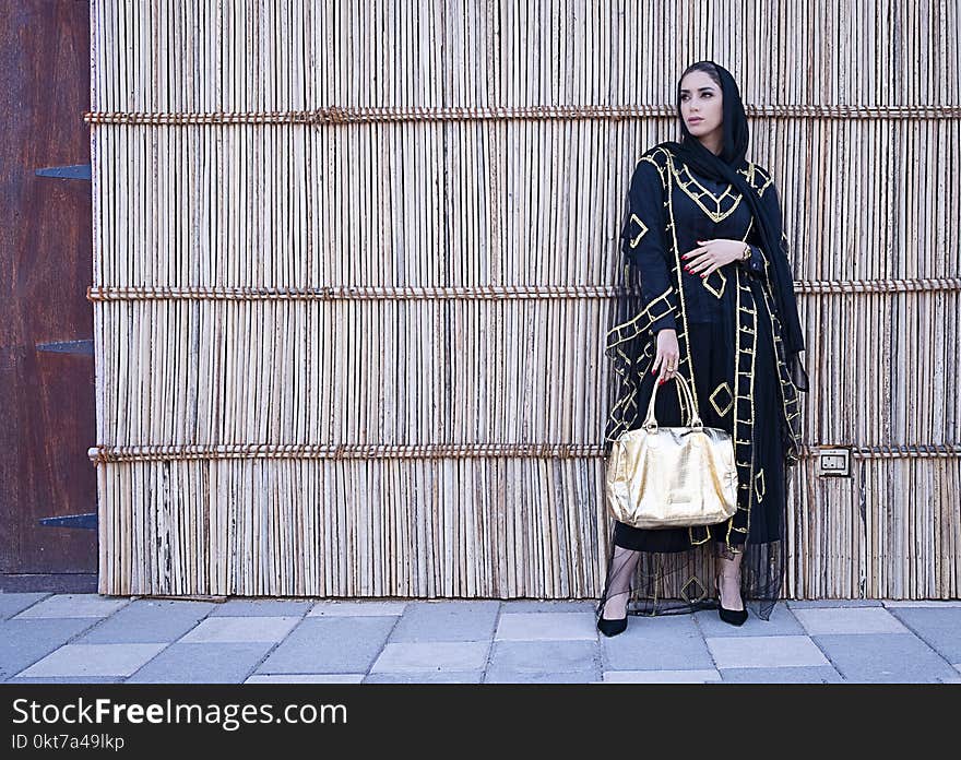 Woman in Blue and Beige Long-sleeved Dress Holding a Yellow Bag