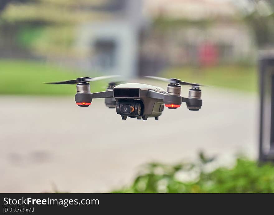 Selective Focus Photo of Flying Gray Quadcopter