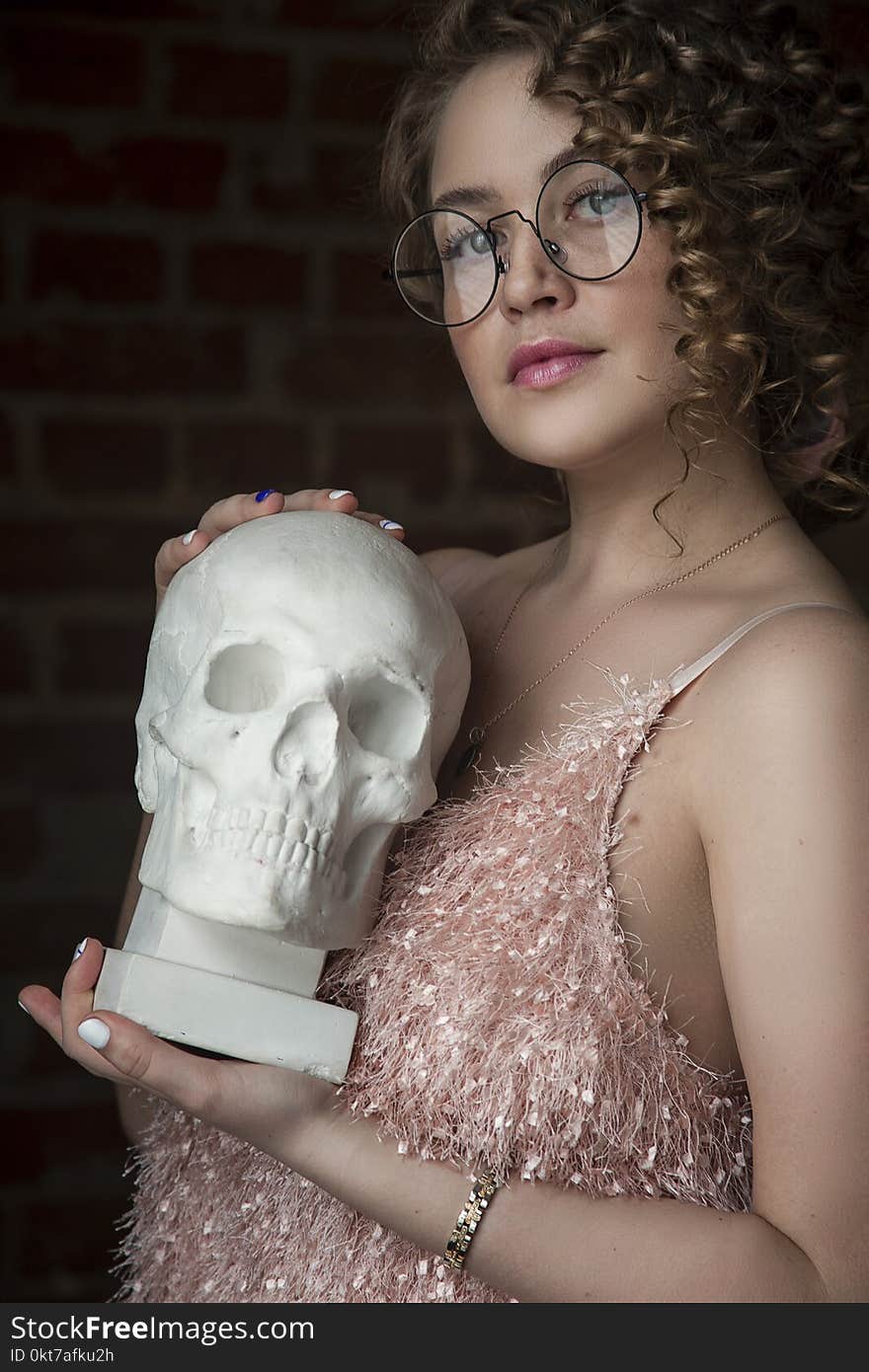 Woman Holding Skull Replica