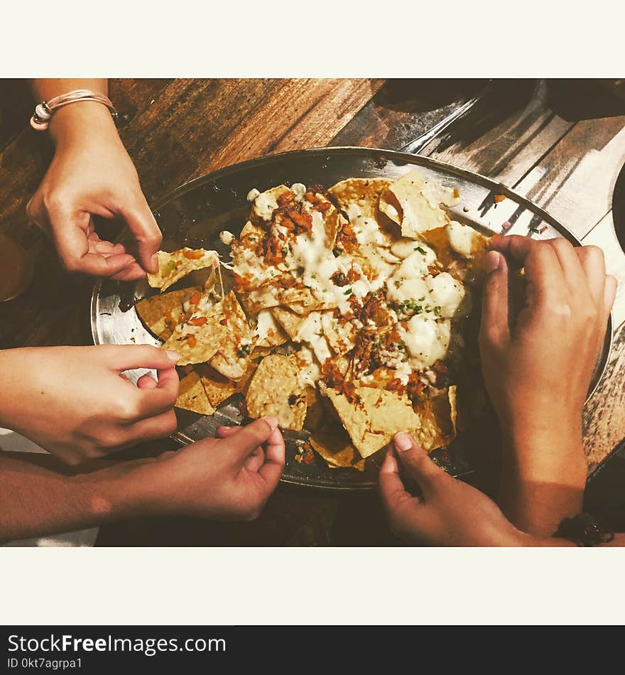 Close-up Photography of People Picking Nachos Chips