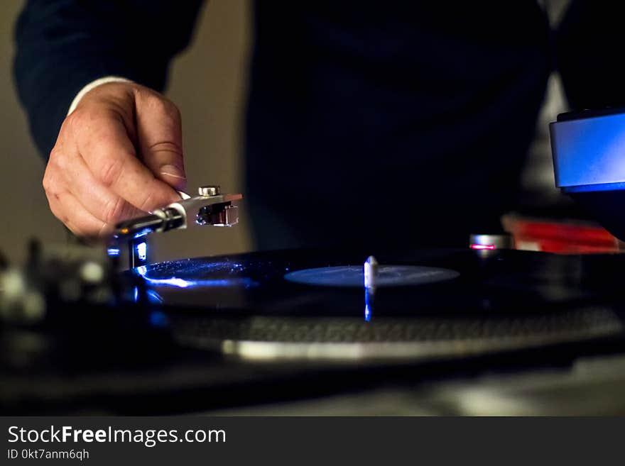 Person Holding Vinyl Player in Shallow Focus Photography