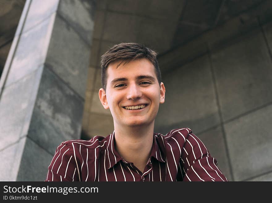 Man in Red and White Striped Collared Shirt Smiling