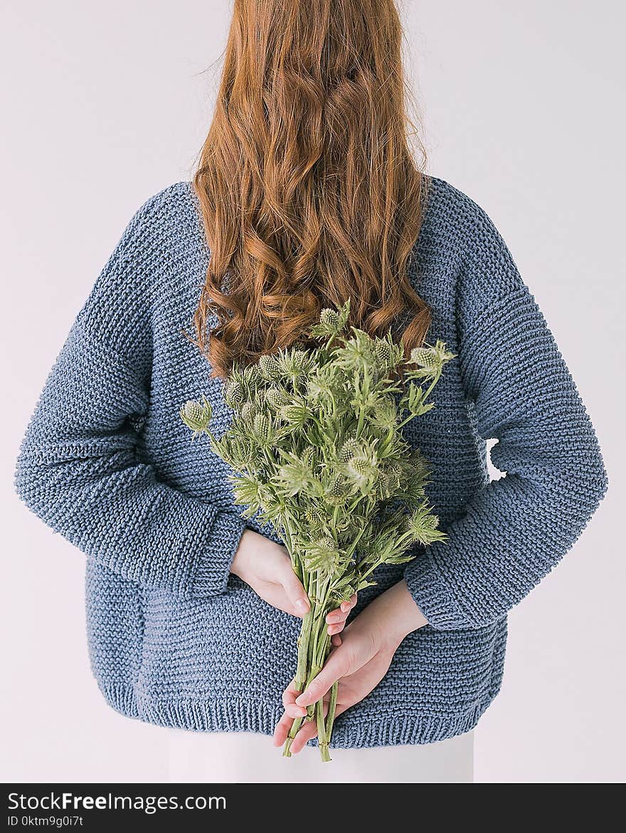 Woman in Gray Sweater Holding Green Leaf Plants