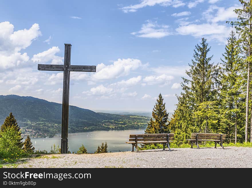 Black Cross Near Body of Water