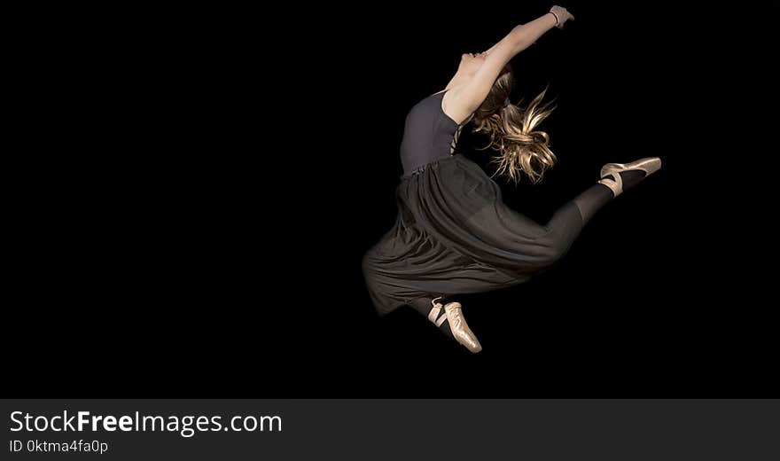 Woman in Black Sleeveless Shirt and Pants Jumping