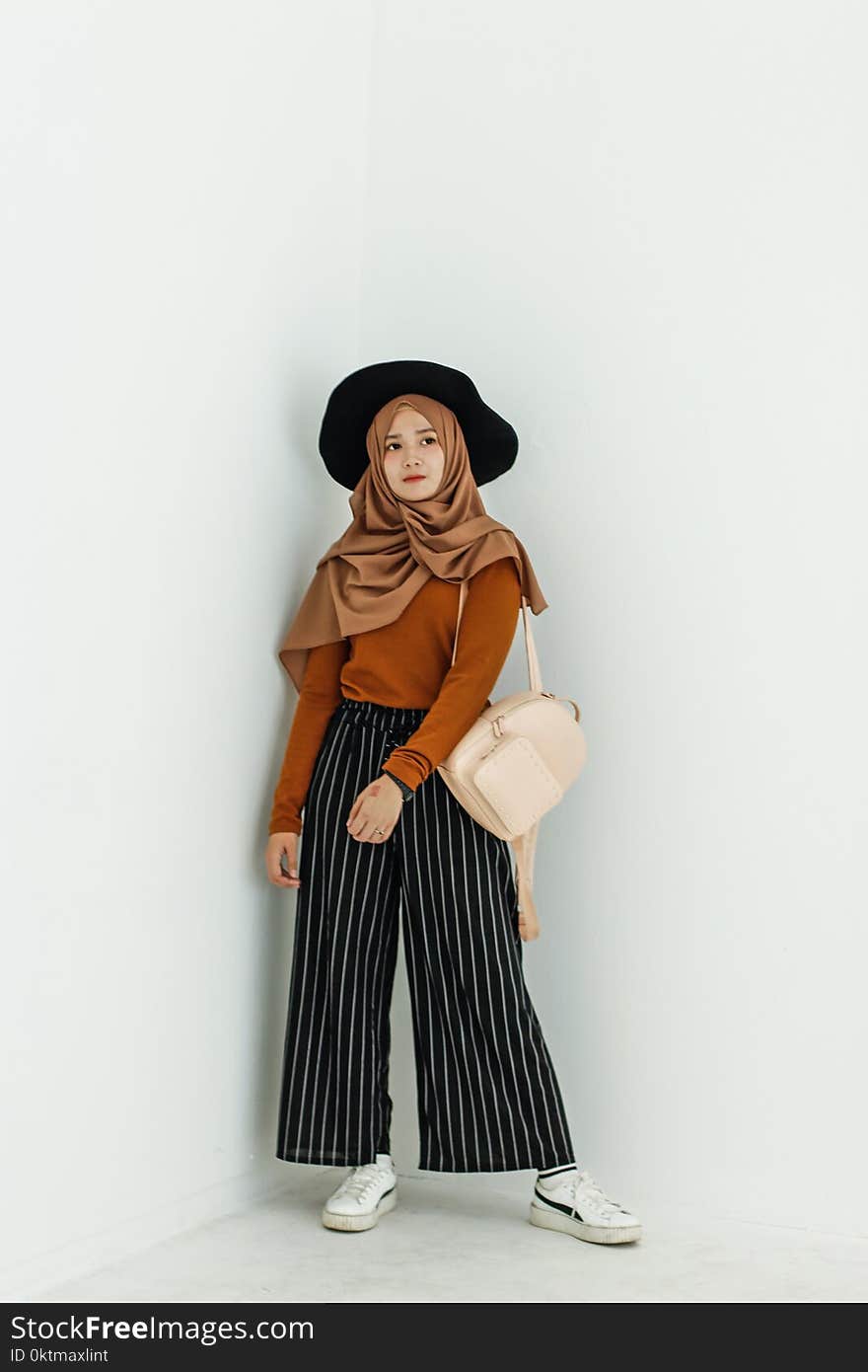 Woman in Brown Long-sleeved Shirt and Brown Hijab Headdress With Beige Leather Backpack