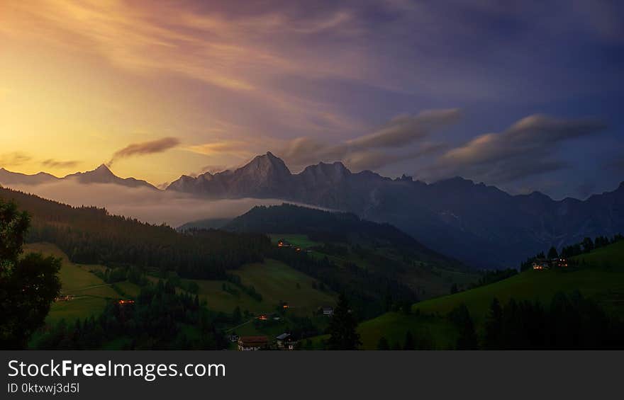 Aerial View Photography of Mountain Under Cloudy Sky