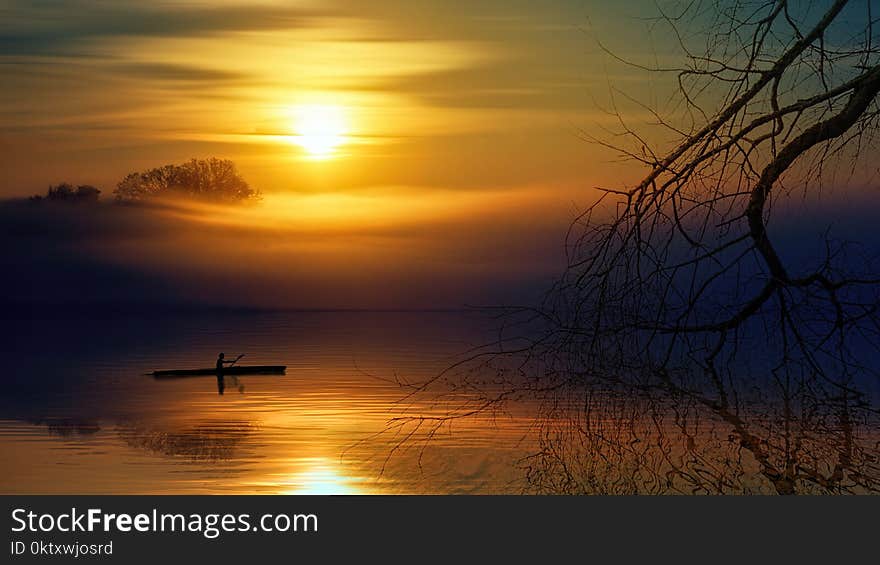 Man Riding Boat during Sunset