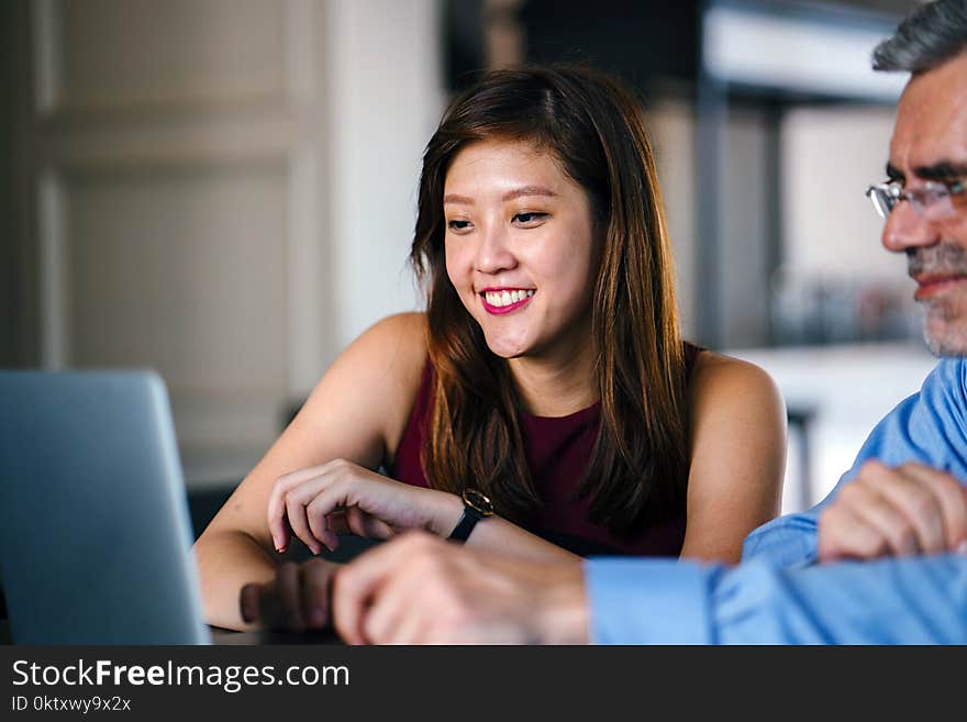 Woman And Man Looking At Laptop