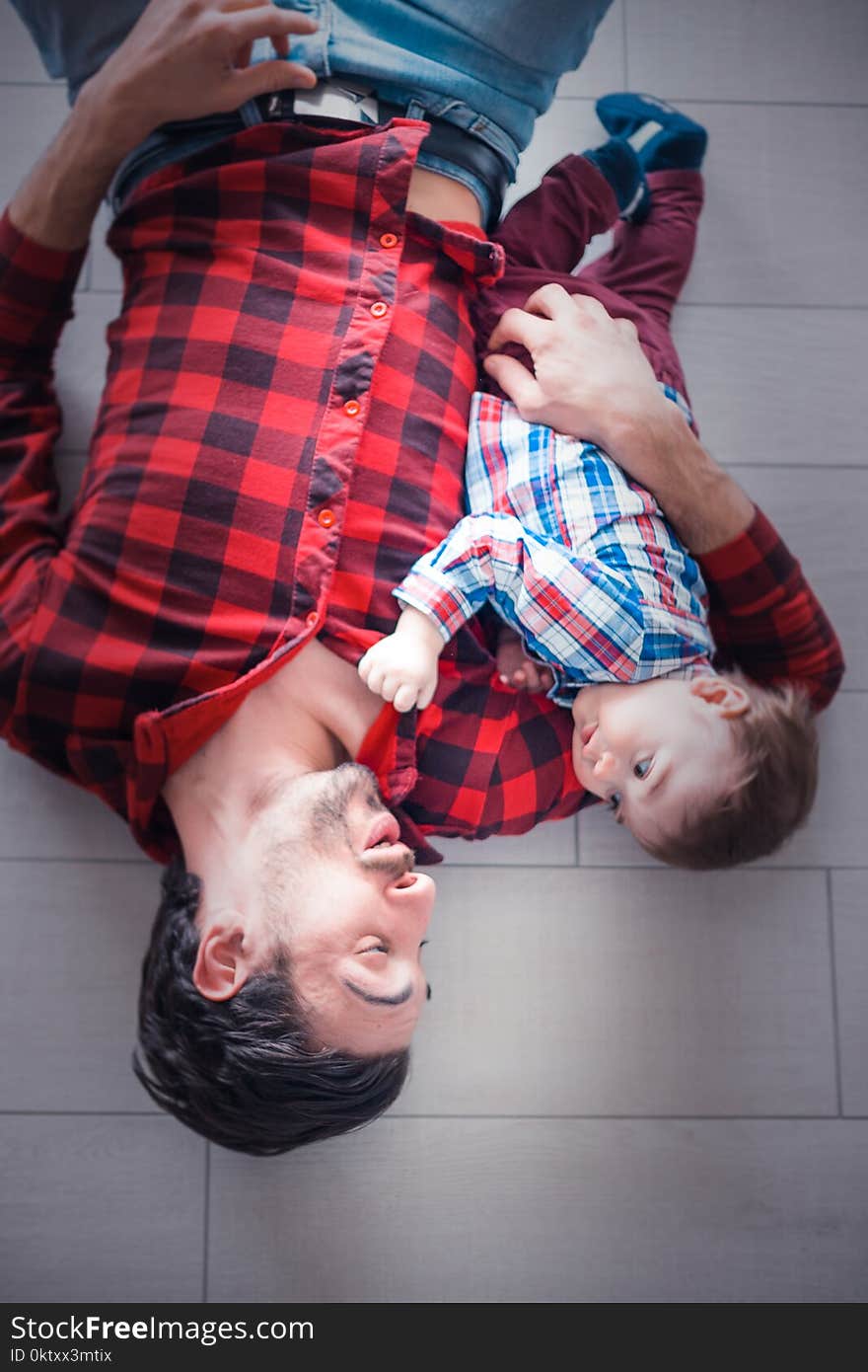 Baby Lying on Man&#x27;s Arm