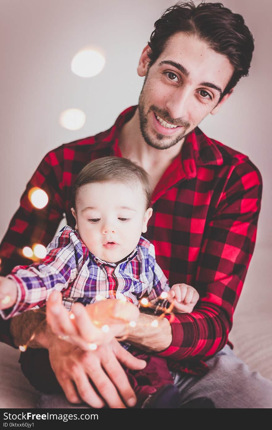 Baby Sitting on Man&#x27;s Lap