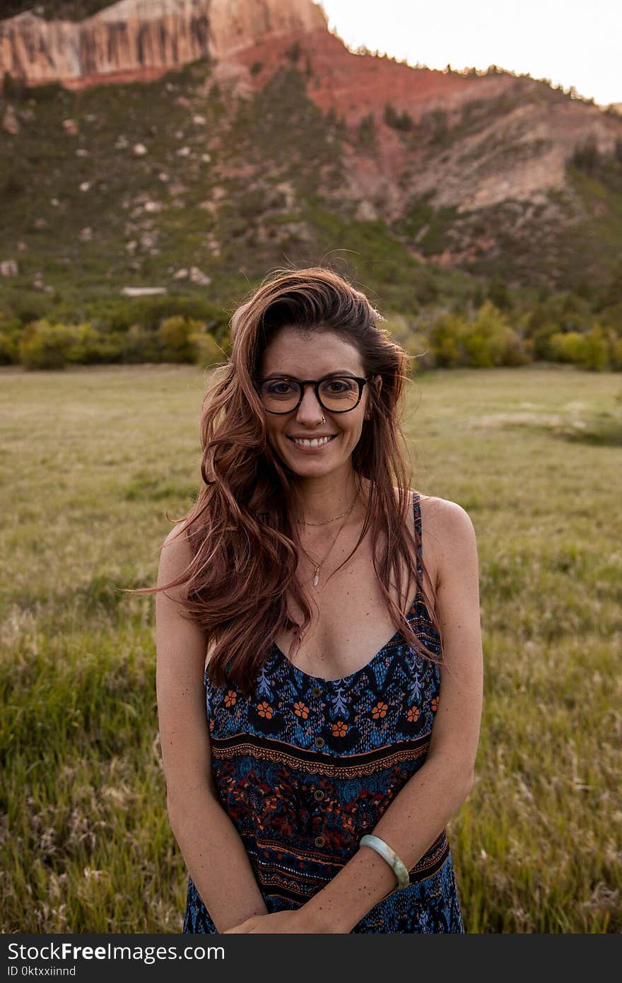 Woman Wearing Multicolored Spaghetti Strap Dress Standing Near Green Grass at Daytime