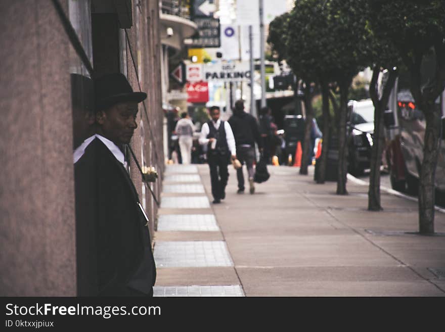 Man Wearing Black Blazer Beside Building