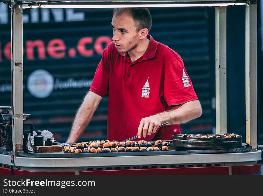 Photo of Man in Red Polo Shirt