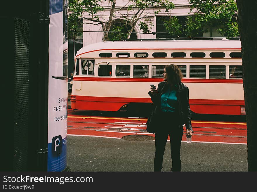 Woman Wearing Black Blazer Beside White and Red Cable Cab