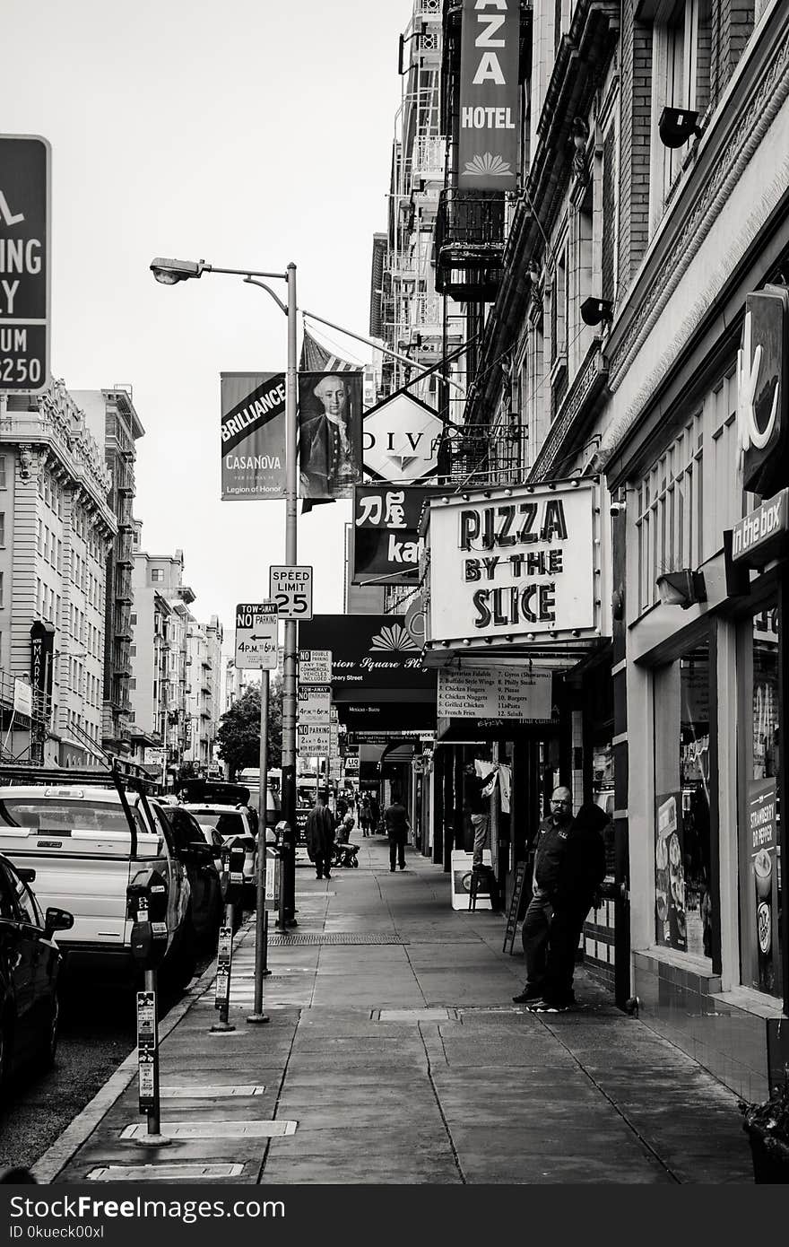 Grayscale Photography of Pizza by the Slice Signage