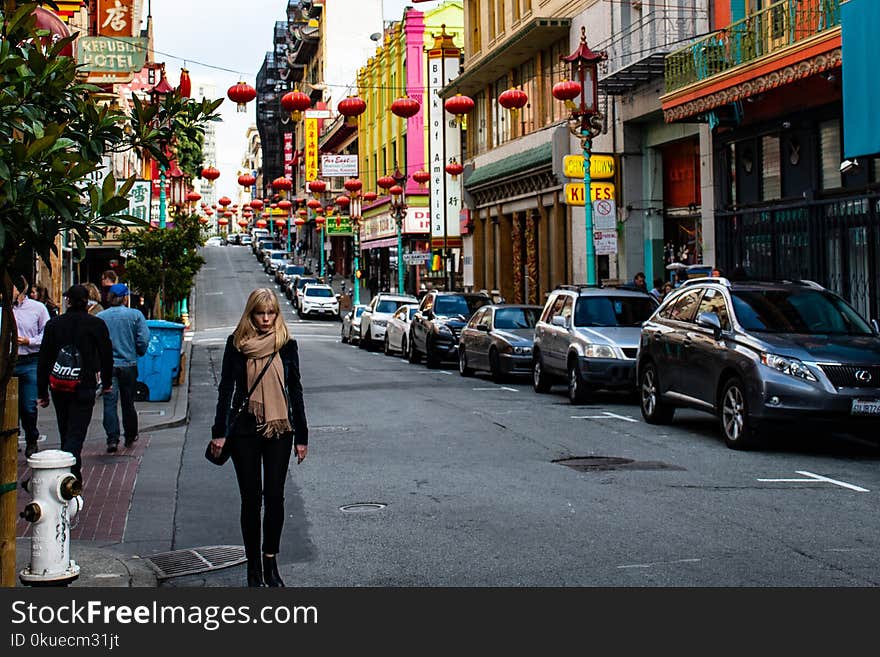 Woman Wearing Black Jacket Walking on the Road