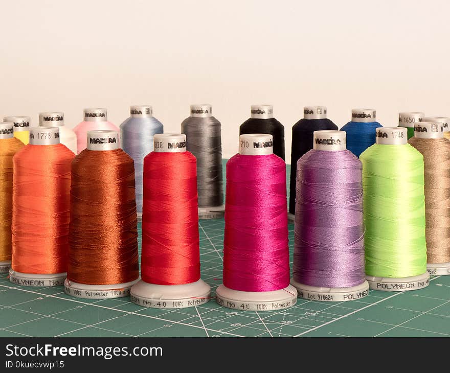 Assorted Sewing Threads on Greensurface