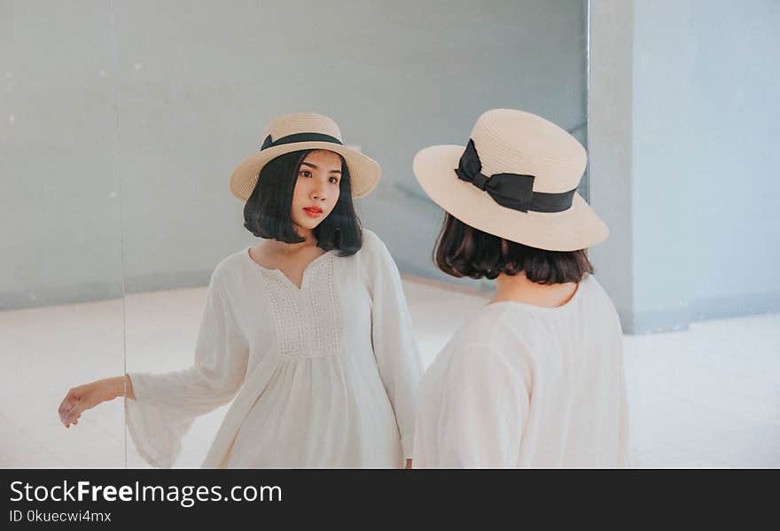 Woman Wearing White Long-sleeved Dress and Beige Sun Hat