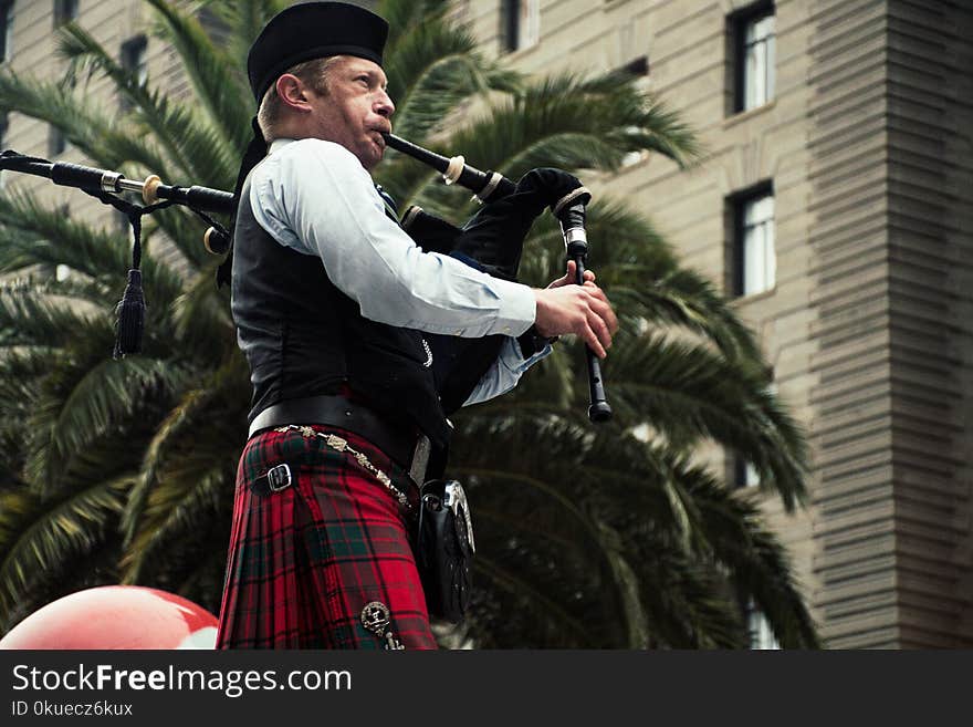 Men Playing Wind Instrument