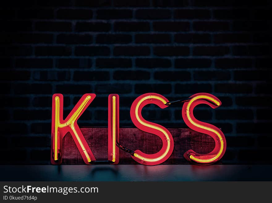 Red Kiss Neon Light Signage on Dark Lit Room