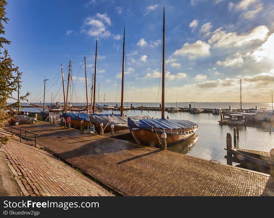 Boats Near Dock Under Gray Sky